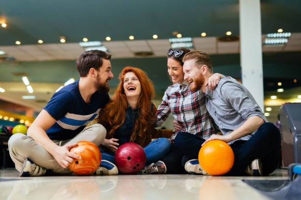 Group of friends enjoying a bowling game together