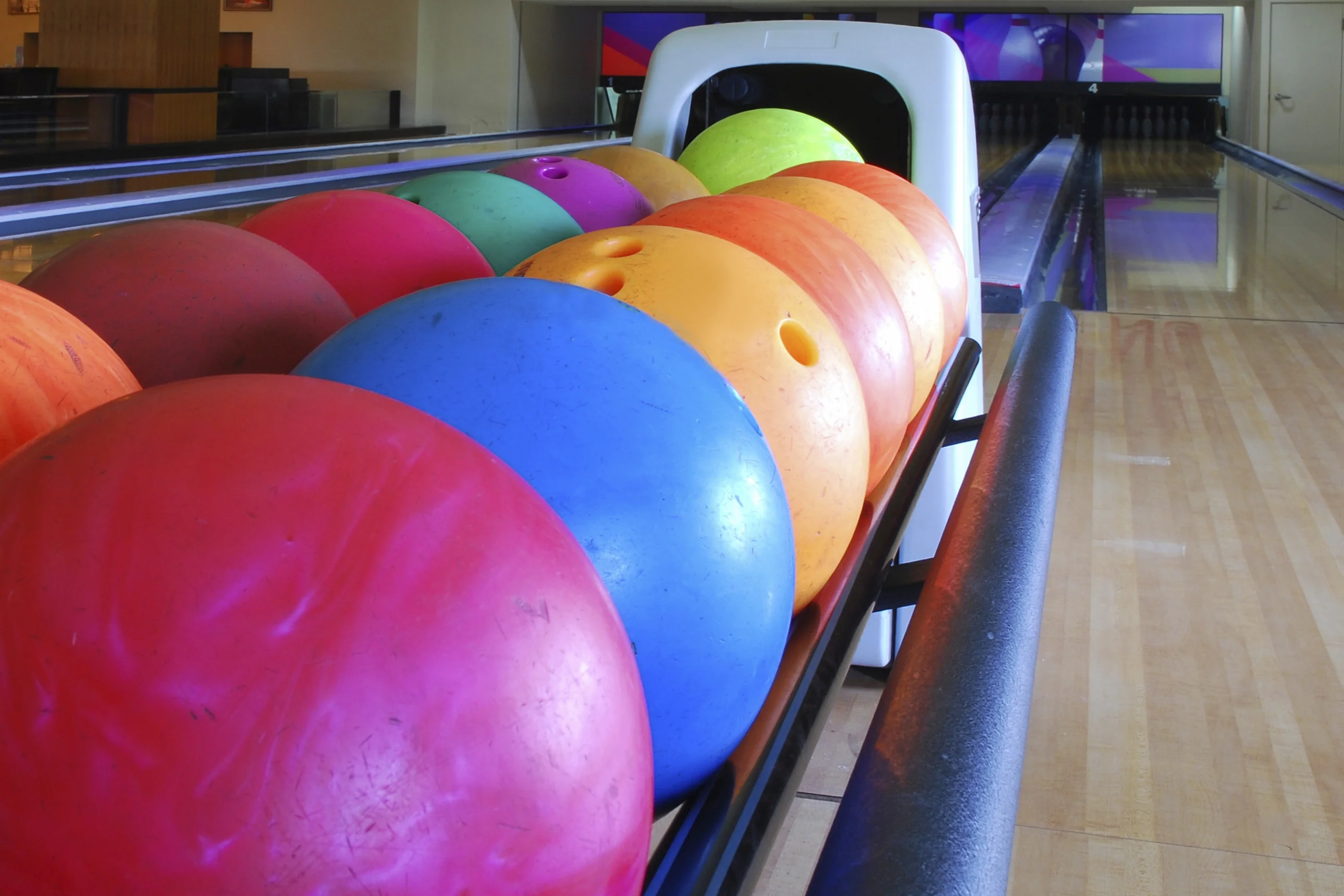 Bowling coach helping a player choose a bowling ball