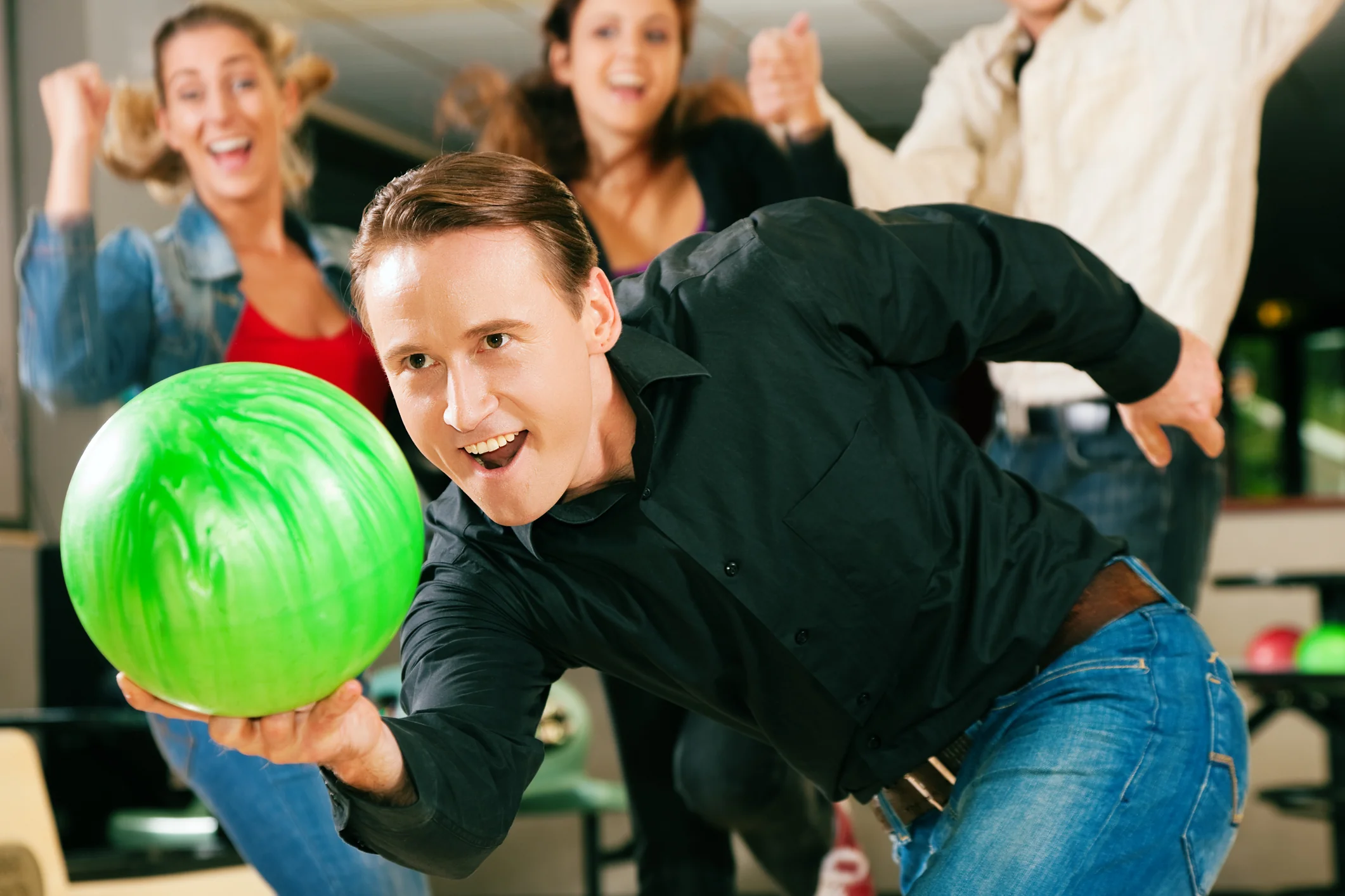 Bowling coach teaching proper throwing technique