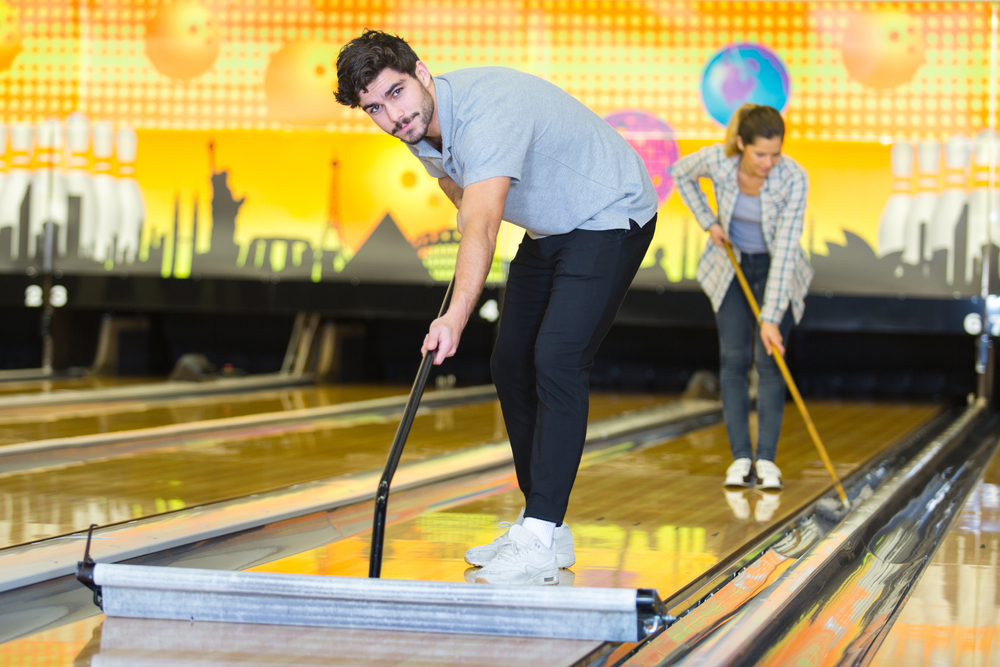 Bowling staff assisting players at the lanes